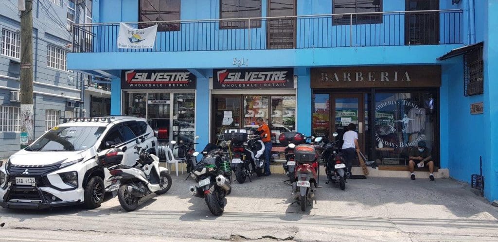 motorcycles parked outside of an auto parts shop