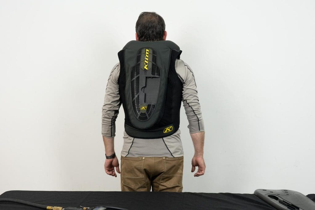 Rear view of individual wearing an inflated Klim Ai-1 airbag vest