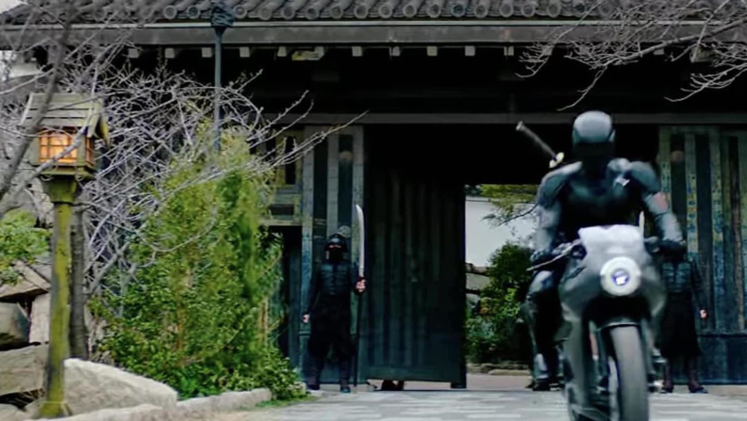 a view of a character riding out of a Japanese house in the action film "Snake Eyes: G.I. Joe Origins"