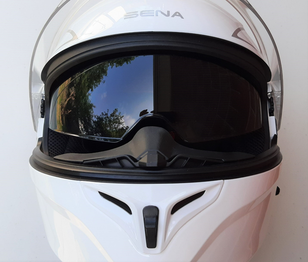 A view of the white Outrush R Modular Helmet, with the sunglasses option flipped down