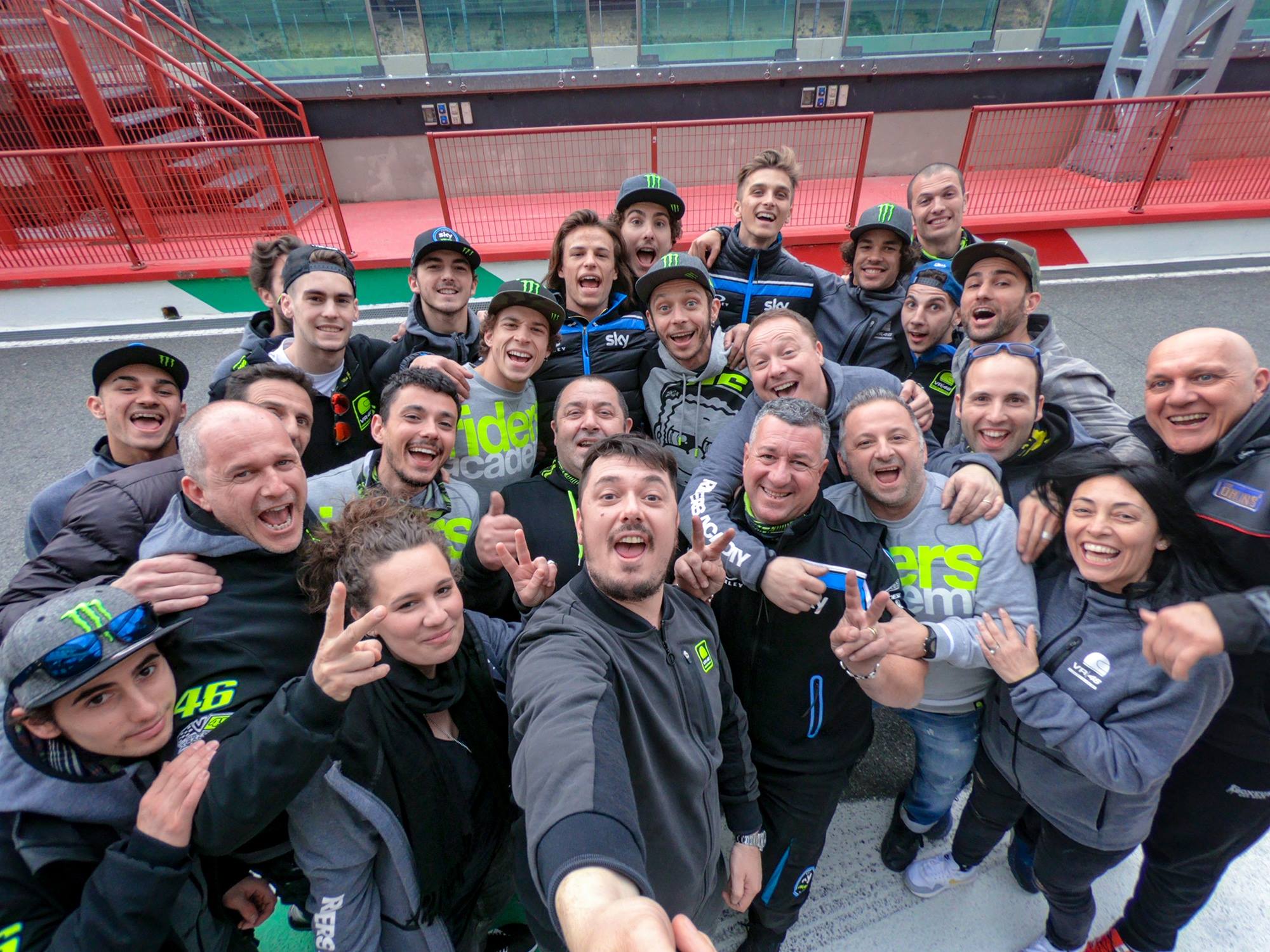Valentino Rossi at the VR46 Riders Academy, taking a selfie with the team and the participants
