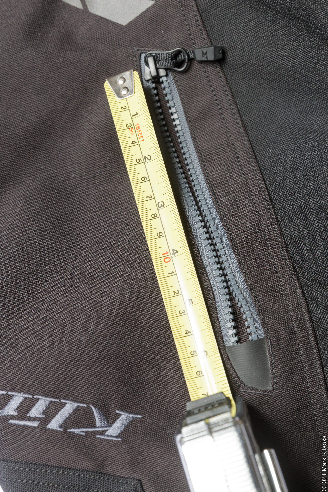 Closeup showing thigh pocket zipper opening about 5.5”