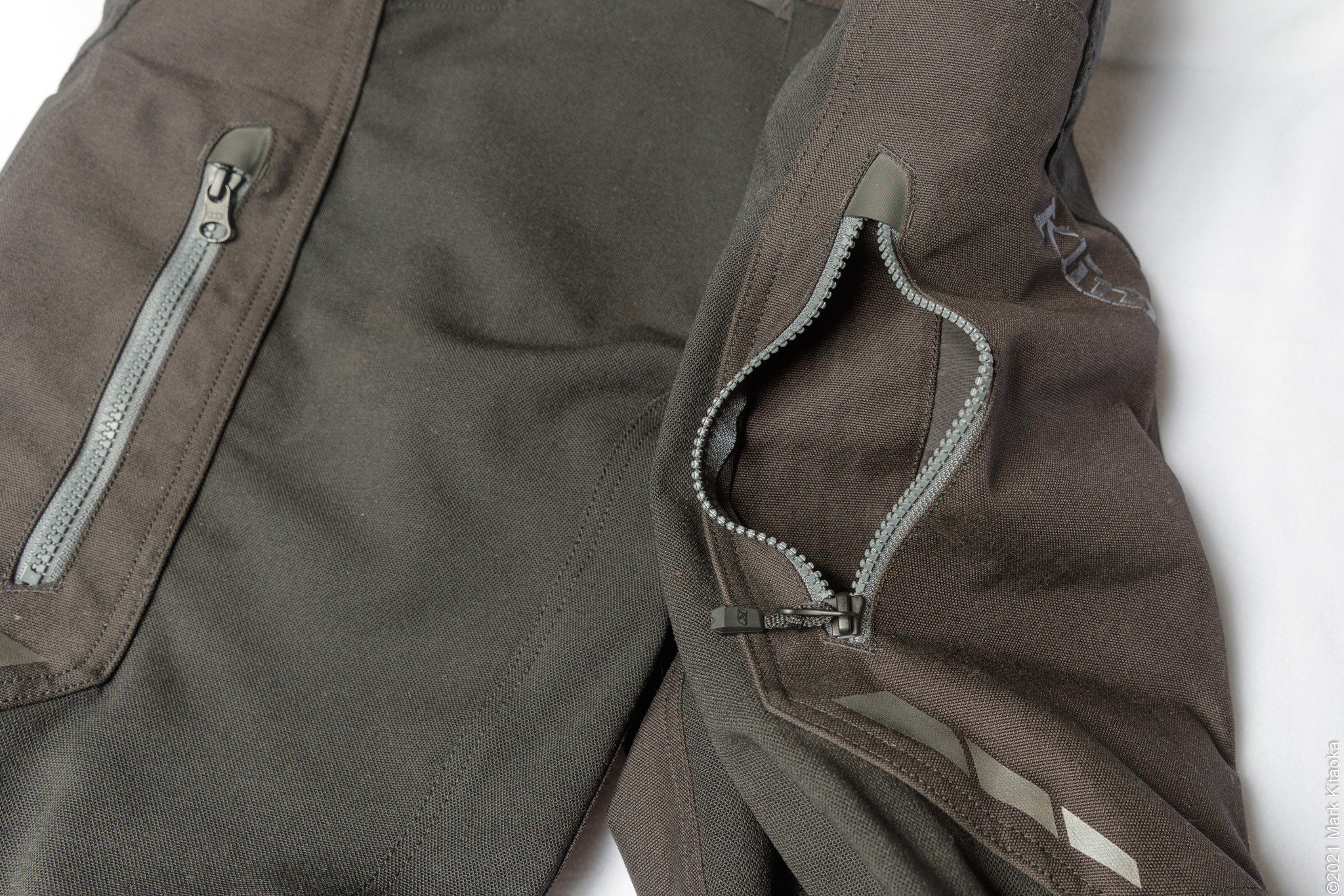 Closeup showing open upper zippered thigh pockets
