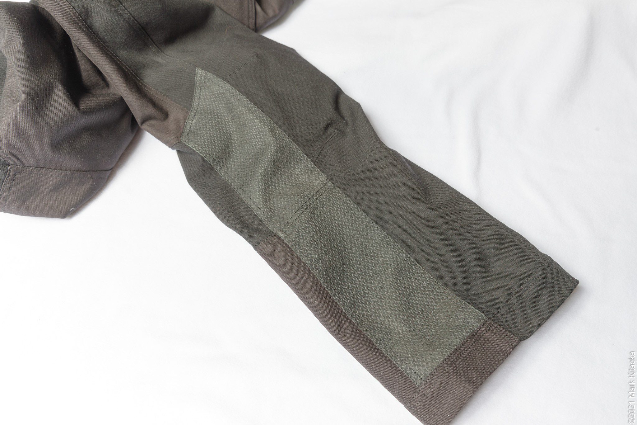 Heat shield material on the inner calf of each leg.