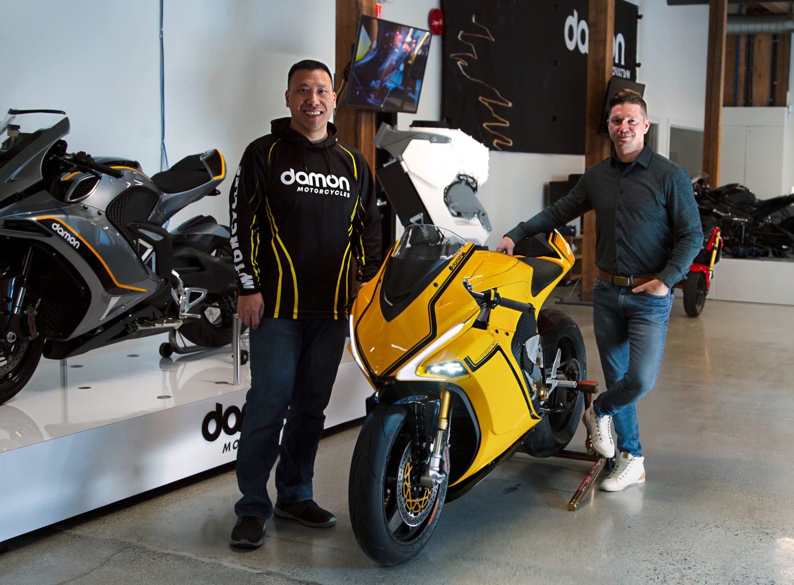 CEO Jay Jiraud with his hand on the Damon HyperSport motorcycle