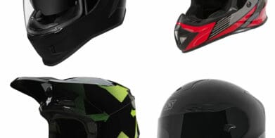 Four motorcycle helmets on white background