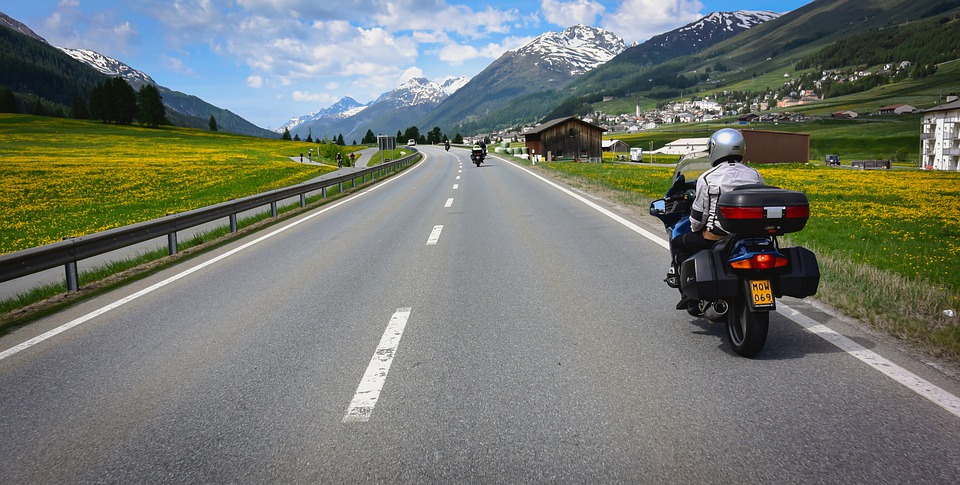 Motorcyclist on a touring bike parked on the side of the road