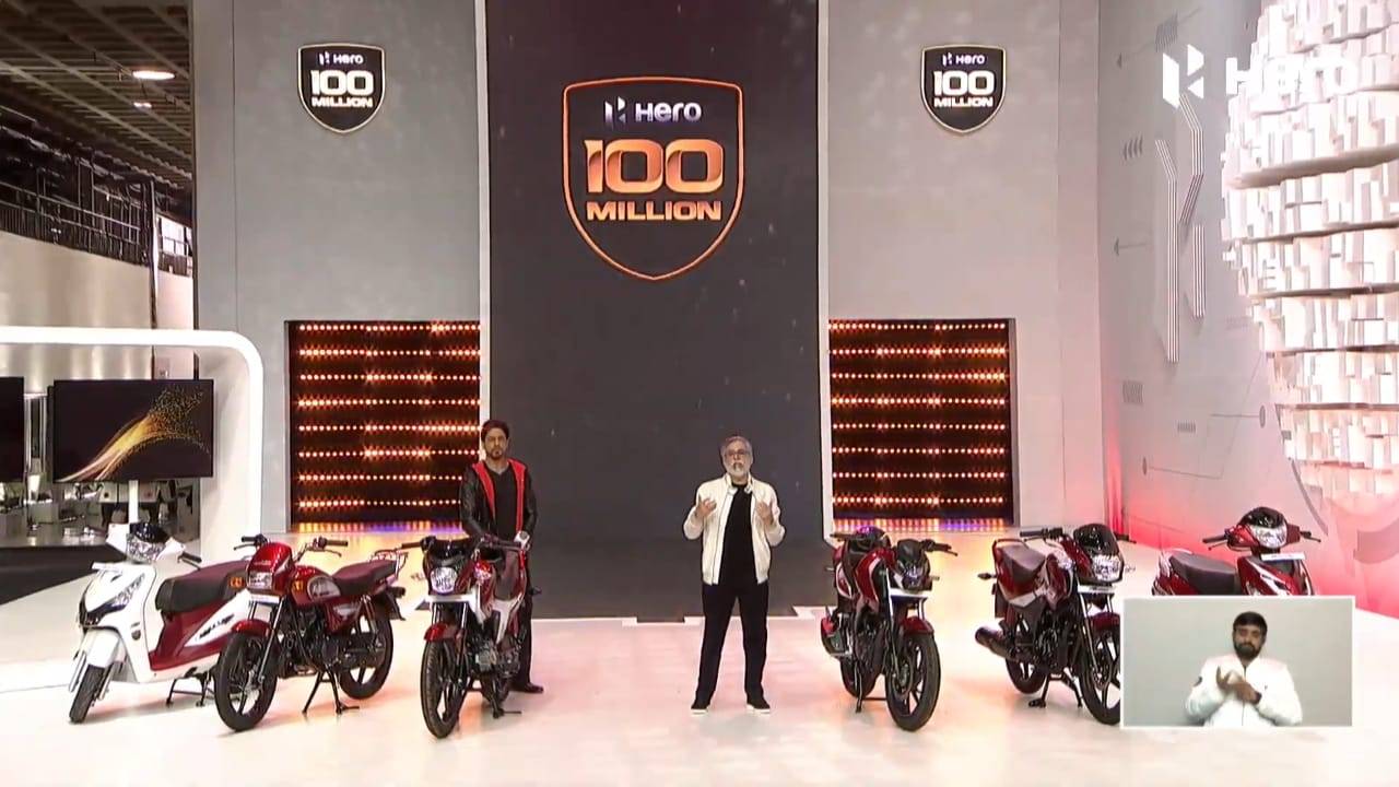 A view of two presenters showing off bikes fro Hero Motorcorp in India