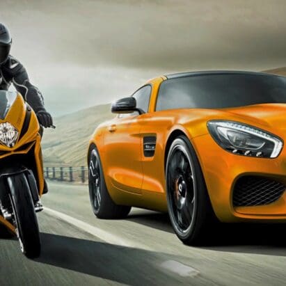 A view of a motorcyclist and a car