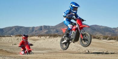 A young rider riding the dirt on a CRF-E2