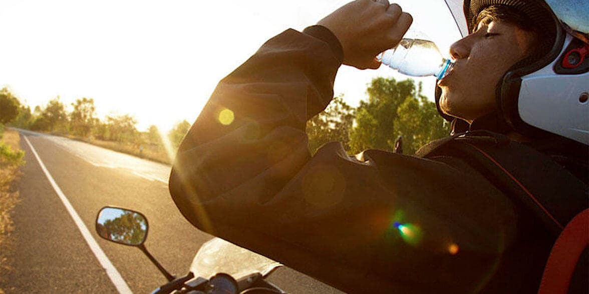 A female motorcycle rider drinking water on a break. Photo courtesy of the Orangeville country BMW Dealership.