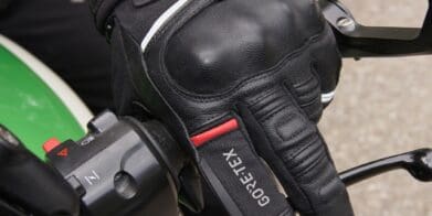 Left Richa Atlantic GTX glove holding motorcycle handlebar