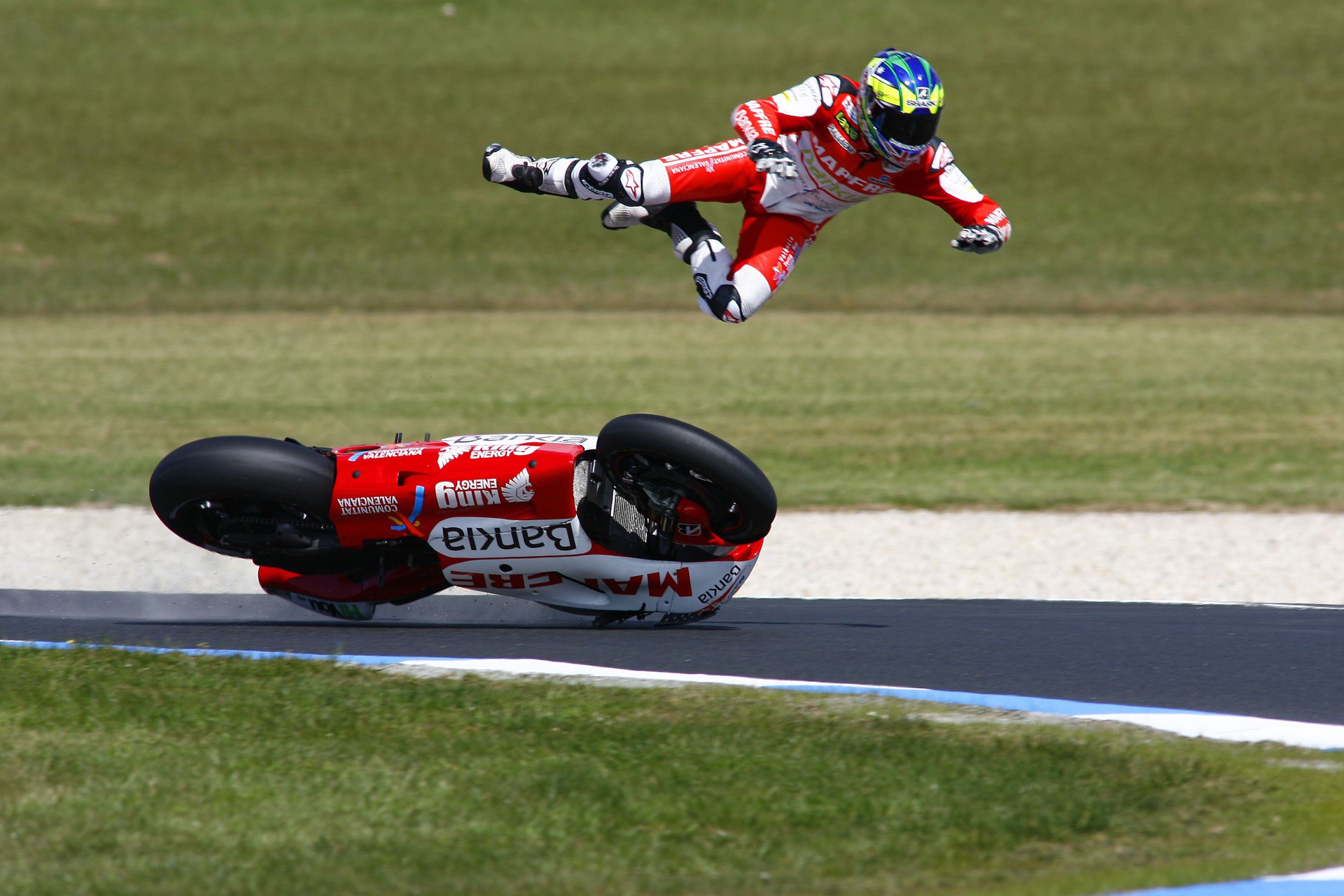 A motorcycle racer suffers a "highside" crash on a racing track