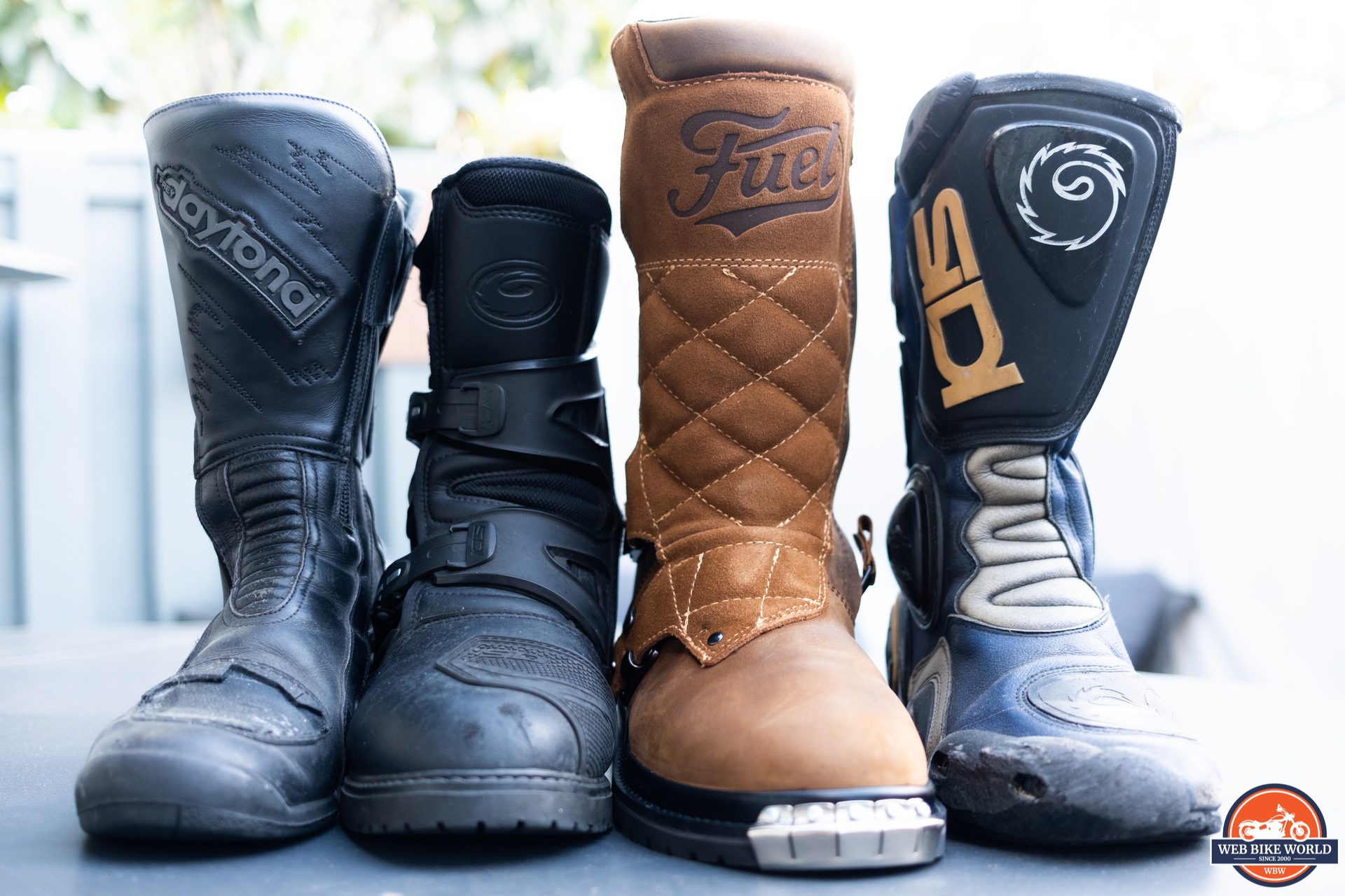 Front view of four different motorcycle boots including a Fuel Dust Devil Boot
