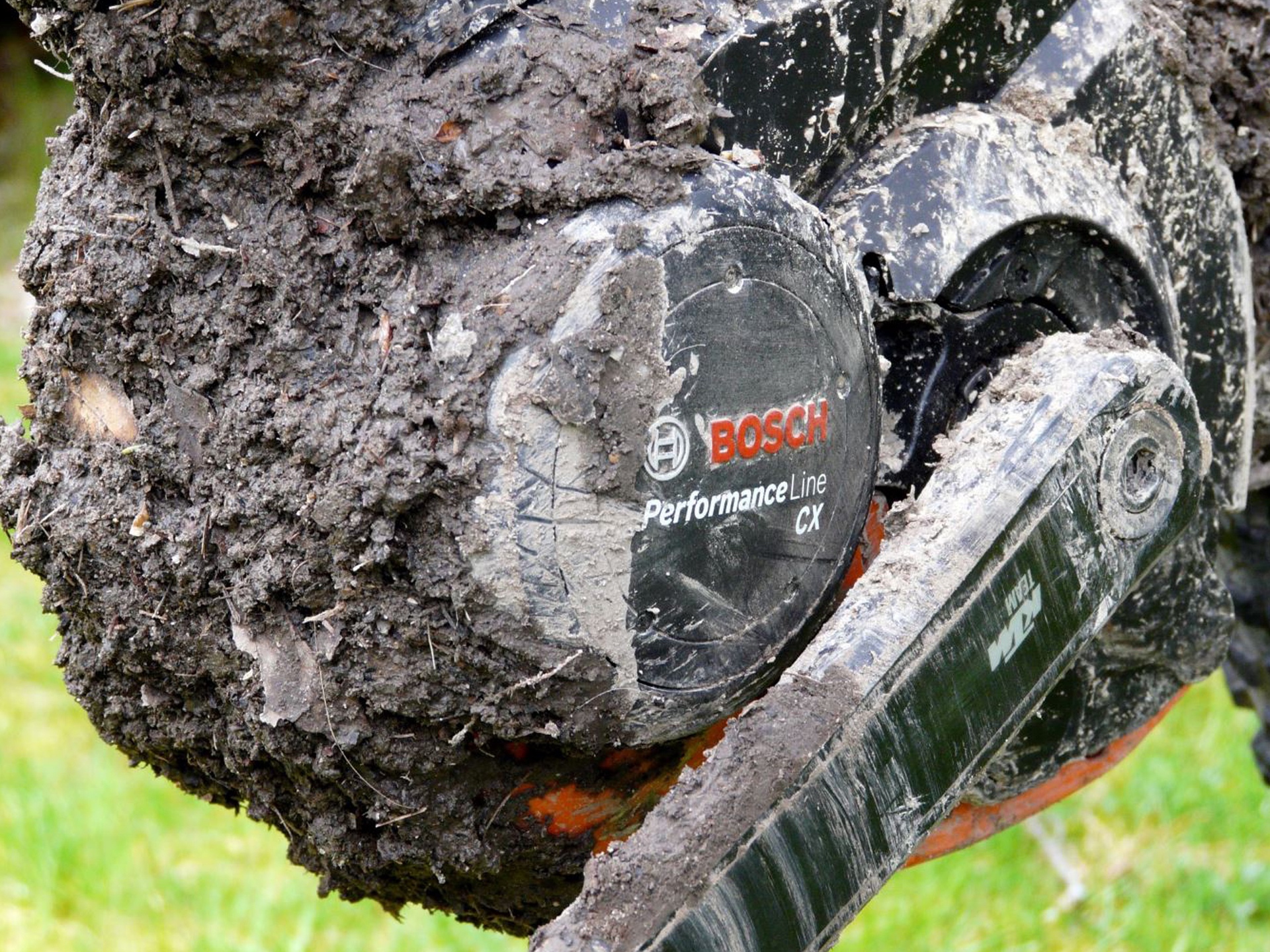 Close up shot of Bosch Performance Line mid-drive eBike motor covered in mud and dirt