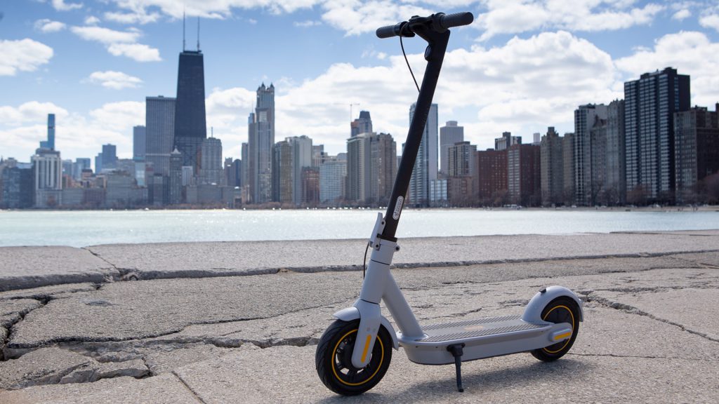 Segway Ninebot G30LP eScooter resting on kickstand with city backdrop