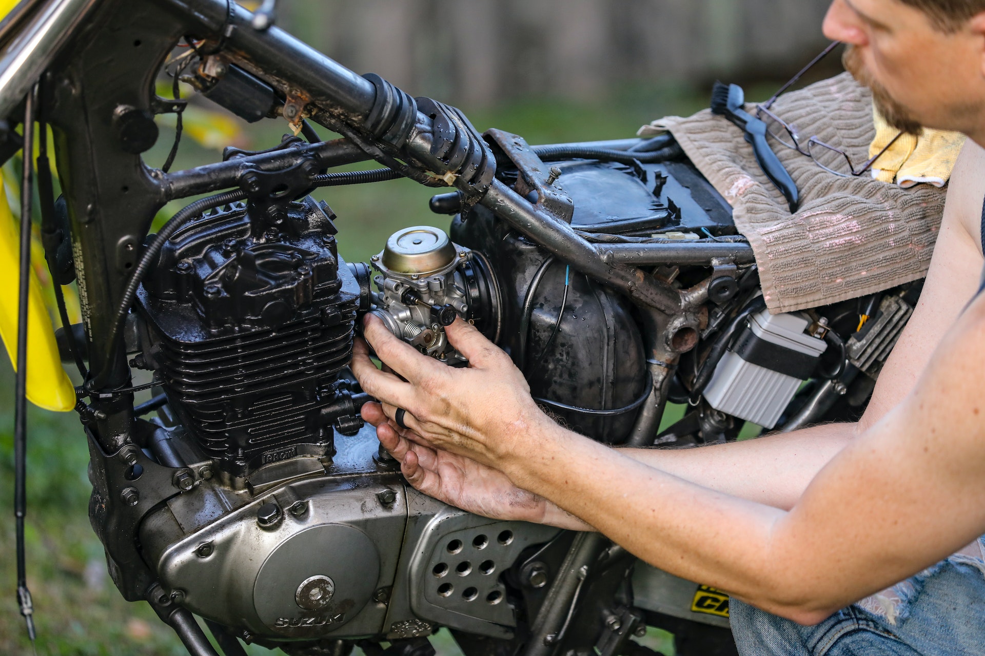 A man fixing motorcycle engine