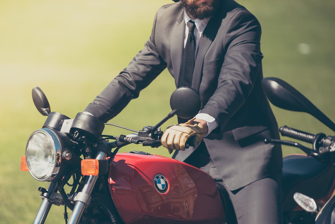 Source: https://www.pexels.com/photo/man-in-gray-suit-riding-red-bmw-motorcycle-173484/ (Free Image)
