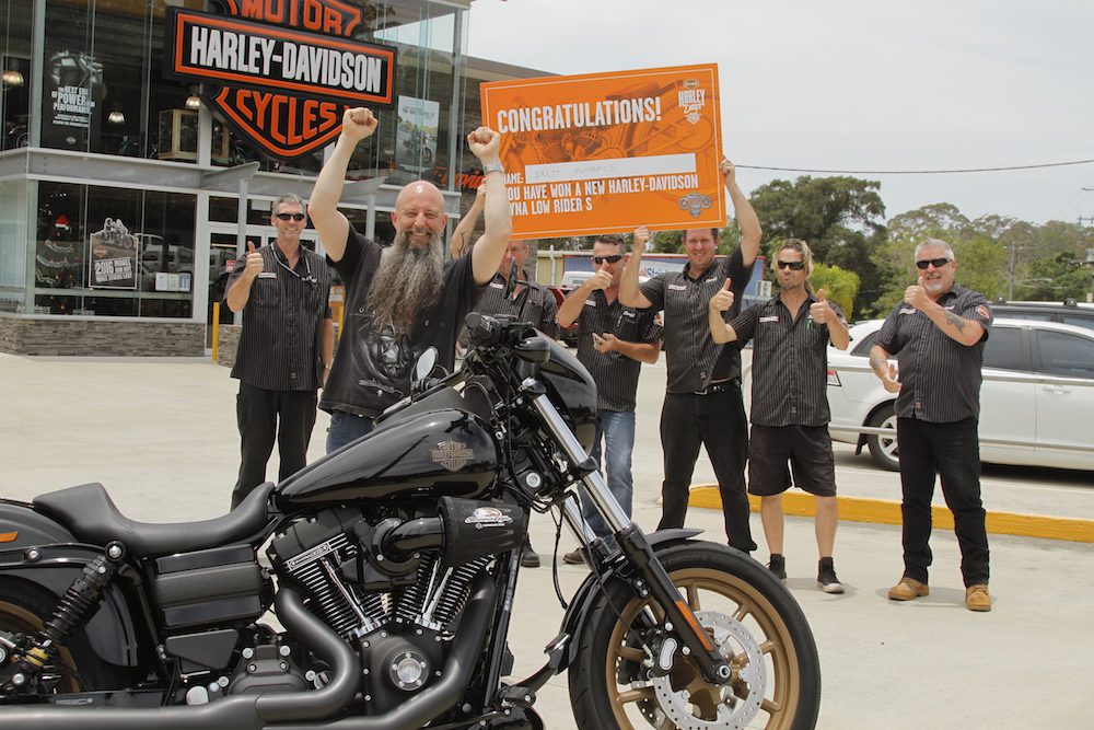 Garry "Gaz" Luxmoore hands over the keys to a Low Rider S to surprised winner Brett Humphries