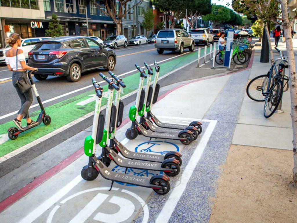 Electric scooters from a ride-sharing company are parked in a spot that's designated for micromobility vehicles.