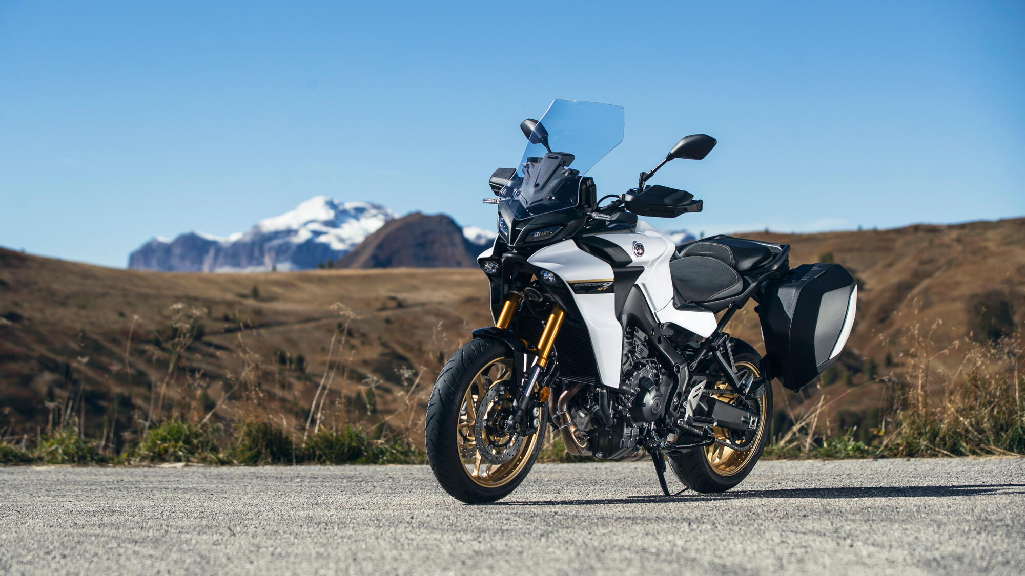 Yamaha's Tracer 9 GT motorcycle parked in front of an alpine vista