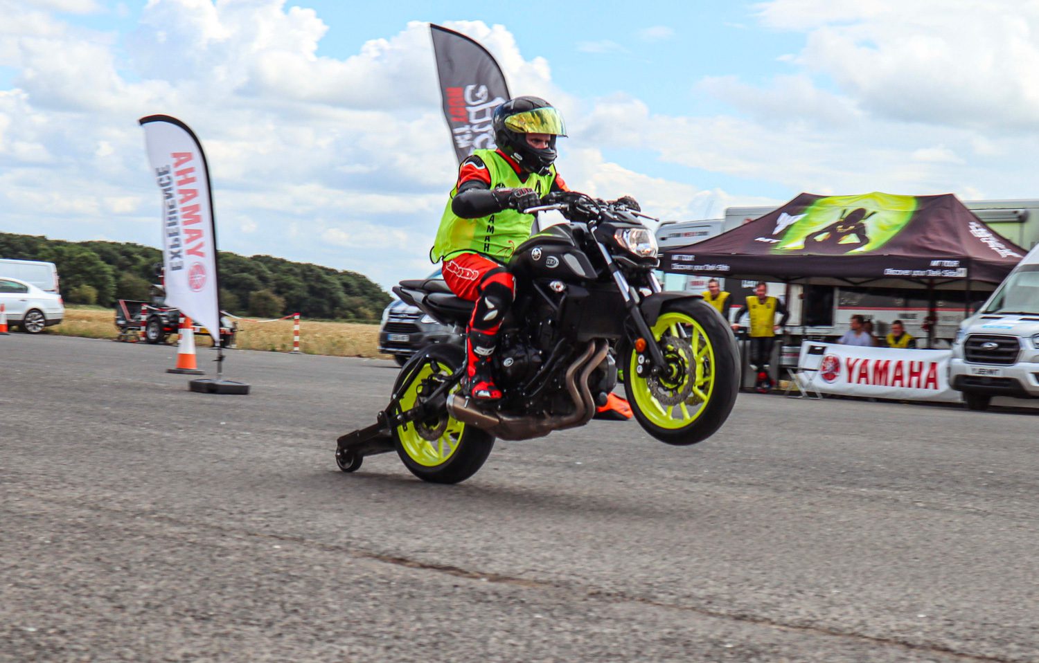A motorcyclist performs a wheelie on a motorcycle