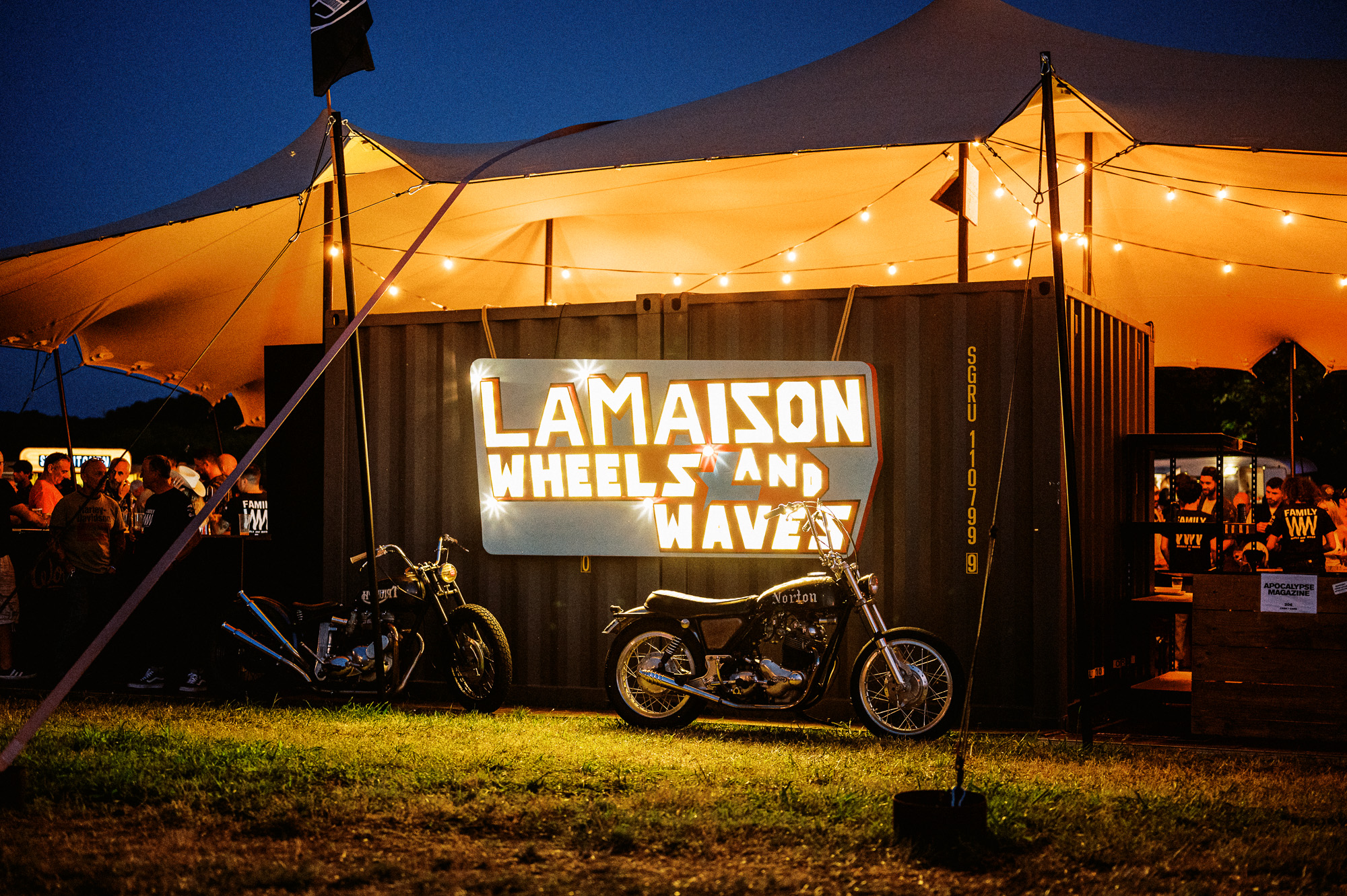 at tent and motorcycles at night at the Waves Bike Show in Biarritz, France