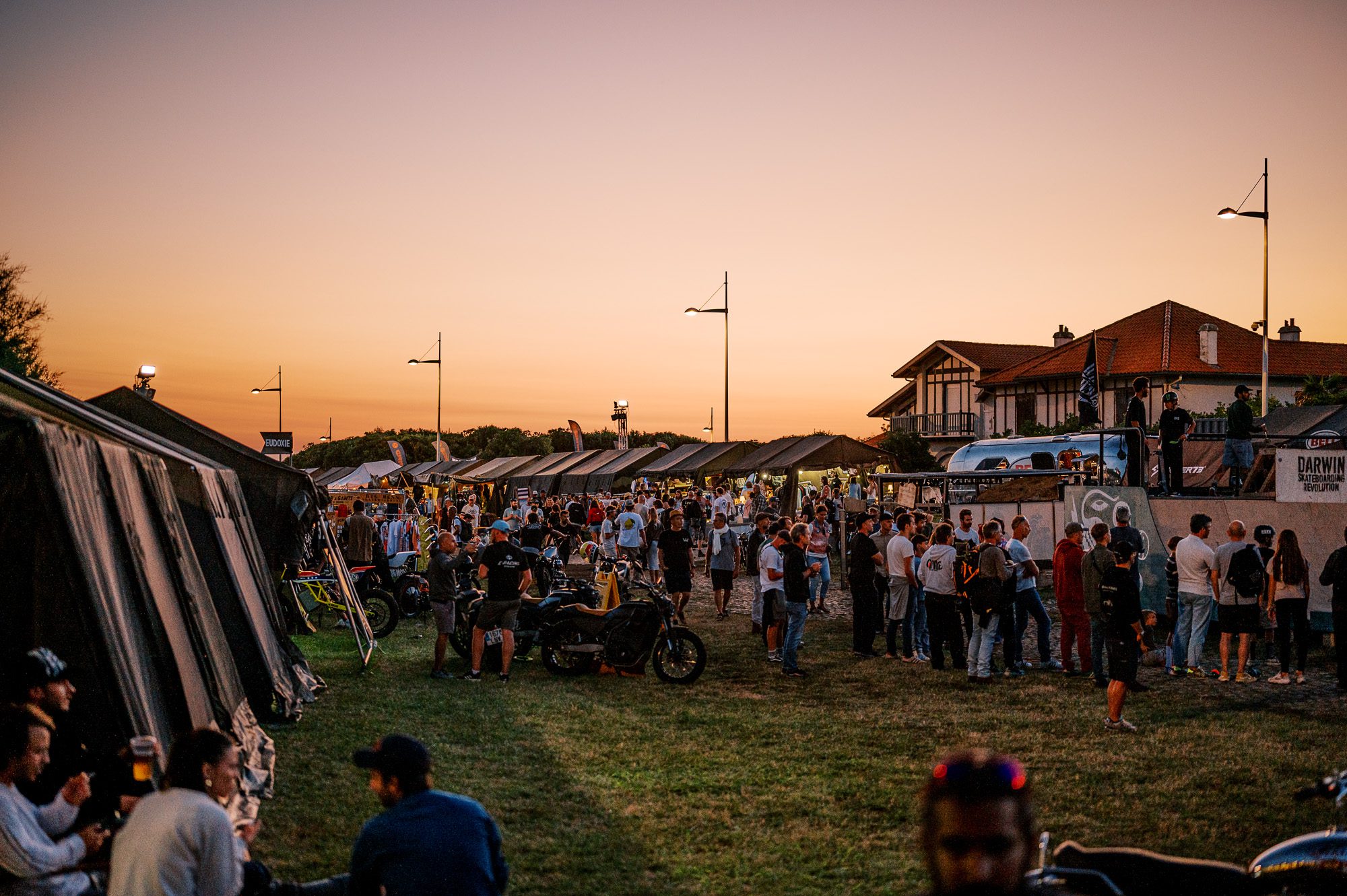 dusk, tents and visitors at the 2023 Wheels & Waves Bike Show in Biarritz, France